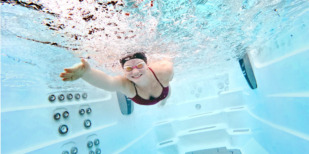 Underwater image of a woman swimming in water.